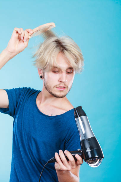 istock Trendy man with hair dryer 638181768