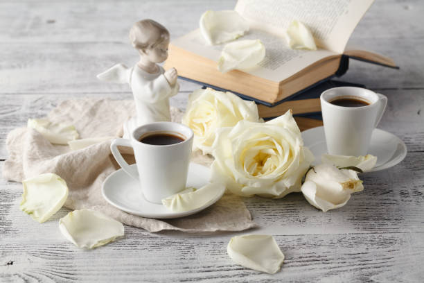 istock Open book and cup of tea on wooden table 638181812
