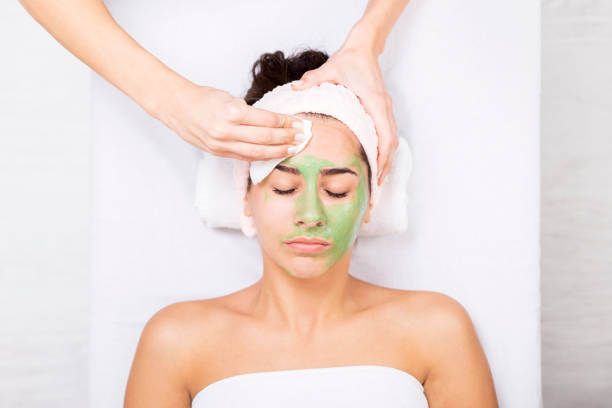 istock Young woman in a spa with algae facial mask 638181874