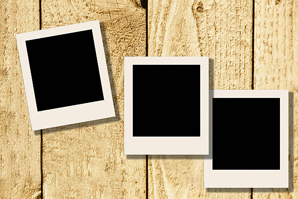 istock Blank, polaroid-style photographs on rustic wooden table. 638182648