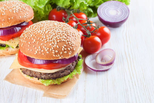 istock Homemade cheeseburger on white wooden surface. 638184352