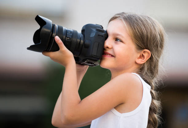 istock girl  holding photo camera 638184354