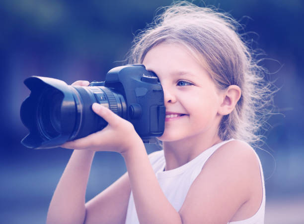 istock girl  holding photo camera 638184496