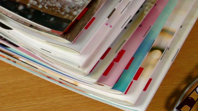 Magazines on table with eyeglasses