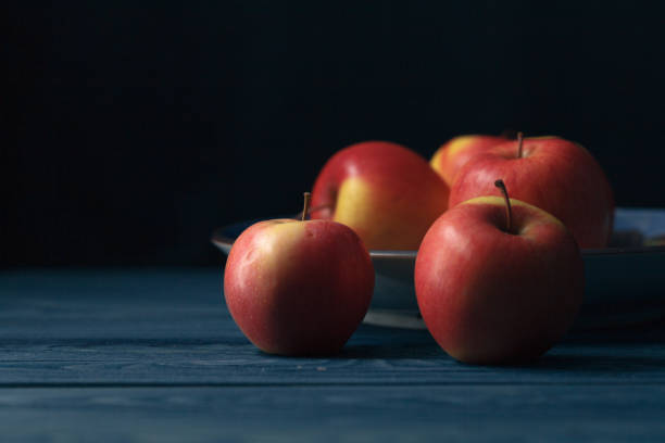 istock Fresh red apples on wooden blue background 638188118