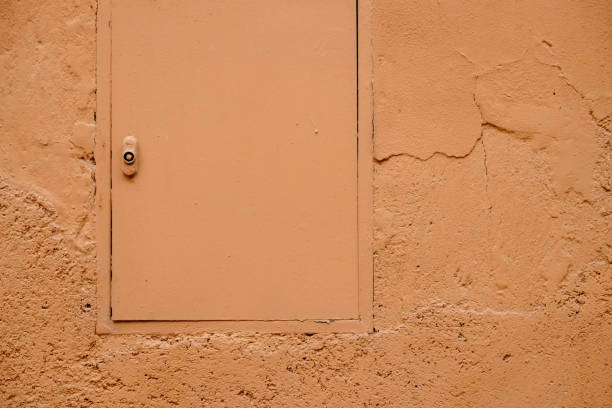 istock Orange pastel color painted hatch and wall 638189726
