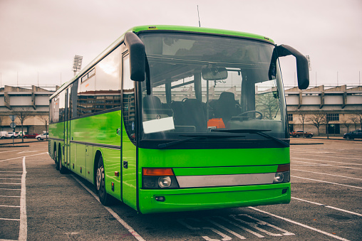 A modern green bus parked
