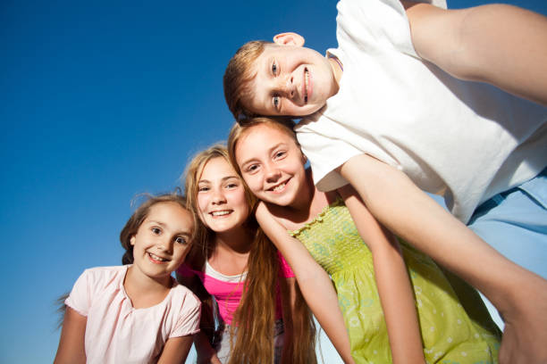 istock four happy beautiful children in the sunny summer day. 638192534