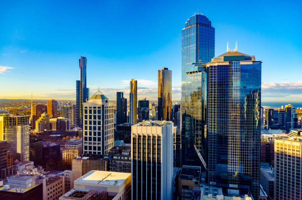 Looking East over Melbourne City at sunrise Looking east toward the Botanical Gardens and sports precinct, visible are Eureka Tower, Rialto building, the Arts Centre spire and AAMI Park melbourne australia stock pictures, royalty-free photos & images