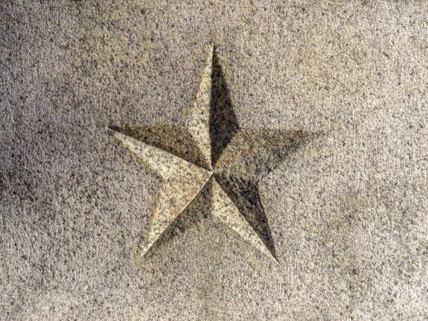Close-up perspective of 5-pointed star carved into granite. 