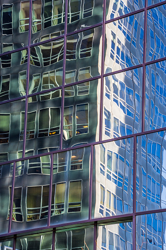 Reflection in glass on a Manhattan skyscraper. New York City, New York.