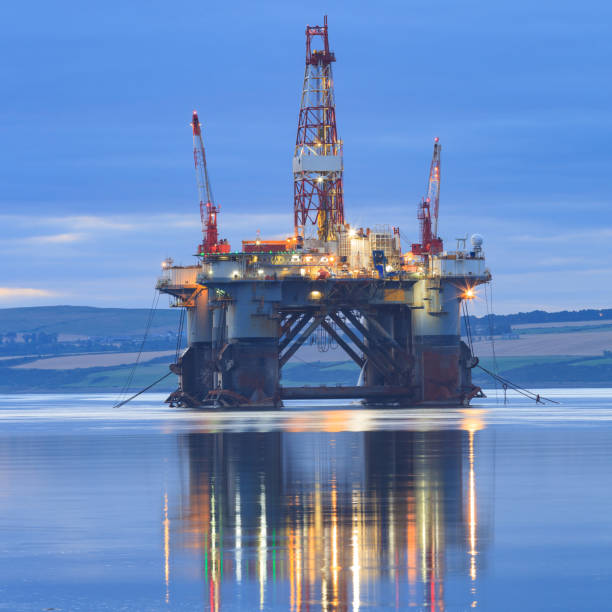 Semi Submersible Oil Rig during Sunrise at Cromarty Firth Semi Submersible Oil Rig during Sunrise at Cromarty Firth in Invergordon, Scotland ballast water stock pictures, royalty-free photos & images