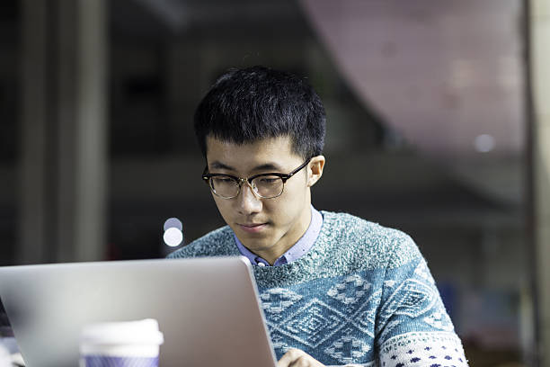 istock young asian man studying with laptop 638200590