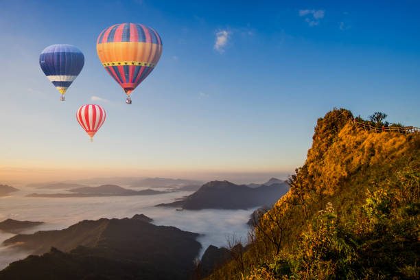 istock Colorful hot-air balloons flying over the mountain 638201726