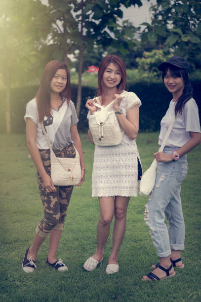 istock three asia young girl with bag on park 638203192