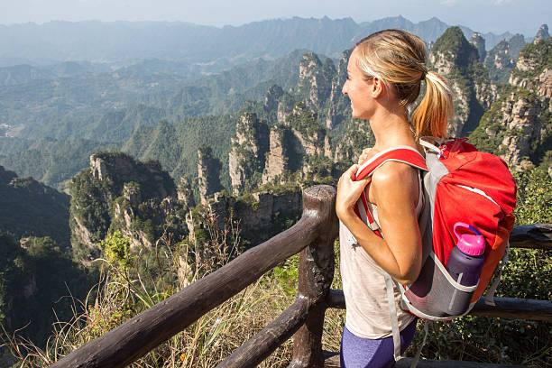 istock Young woman on mountain top contemplating nature 638204834