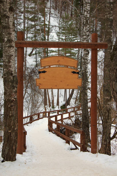 istock Wooden signboard on the winter forest 638205714