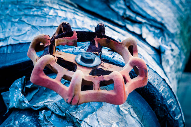 Close-up Of Red Rusty Valve On Pipe.