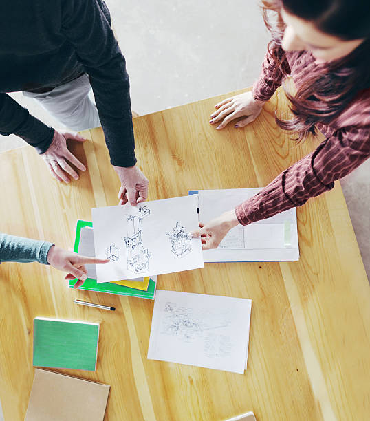 istock Overhead view of designers collaborating at table in studio 638210408