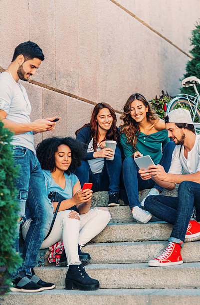 istock Friends browsing the net outdoors 638210522