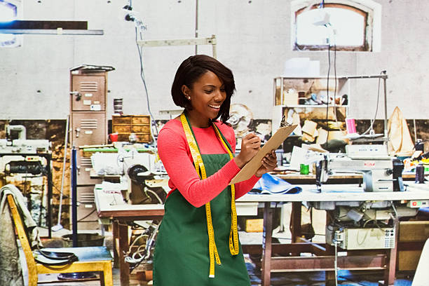 istock Smiling seamstress working in textile industry 638210818