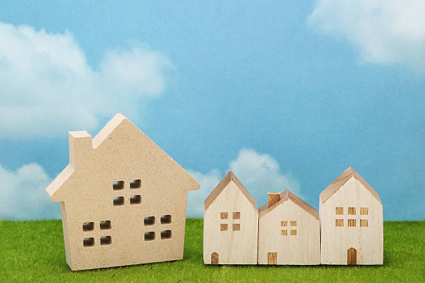 istock Houses on green grass over blue sky and clouds. 638211062