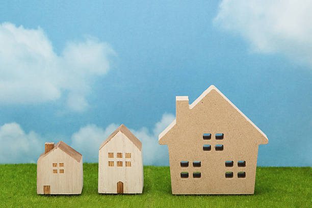 istock Houses on green grass over blue sky and clouds. 638211084