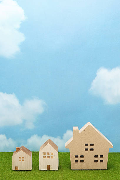 istock Houses on green grass over blue sky and clouds. 638211104