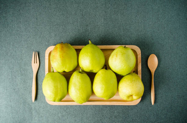 Pear fruit on wooden plate