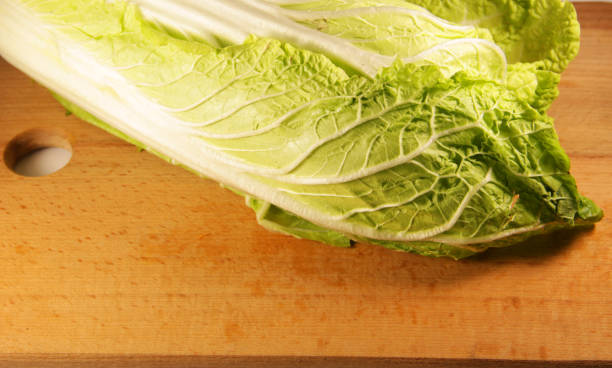 istock Chinese cabbage on the wooden kitchen board 638215816