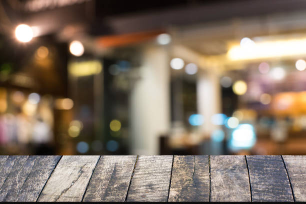 istock Empty vintage wood table over bokeh at night for product 638217044