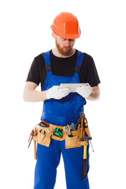 istock Man builder in the uniform with a tablet in hands 638218820