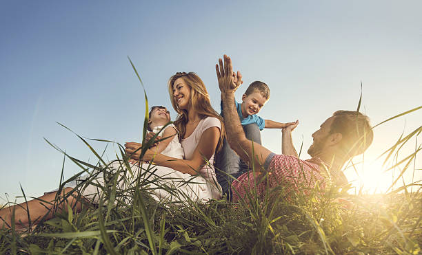 A family with a dad, a teenager and a small child are walking carefree and fun in a field with wheat. It's time to harvest. The food crisis in the world. A field for harvesting bread.