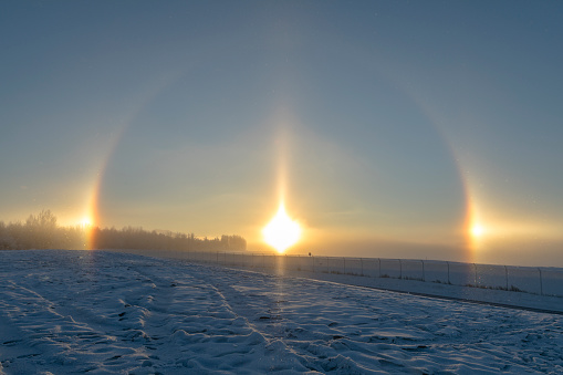 A sun dog (or sundog), mock sun or phantom sun, meteorological name parhelion (plural parhelia), is an atmospheric phenomenon that consists of a bright spot to the left and/or right of the Sun. They often occur in pairs, one on each side of the Sun.