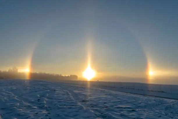 A sun dog (or sundog), mock sun or phantom sun, meteorological name parhelion (plural parhelia), is an atmospheric phenomenon that consists of a bright spot to the left and/or right of the Sun. They often occur in pairs, one on each side of the Sun.