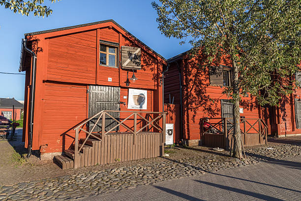 Oulu, Finland - July 21, 2016: Old wooden warehouses  along the harbor in the centre of Oulu in Finland during the midnight sun.