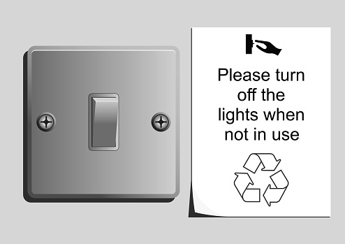 Monochrome light switch with save energy sticker portraying conservation message
