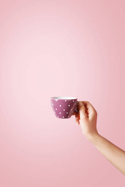 istock Woman hand holding a coffee cup on pastel background 638224494