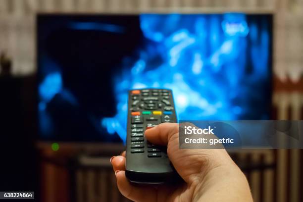 Watching Tv And Using Remote Control Stock Photo - Download Image Now - Television Set, Television Industry, People