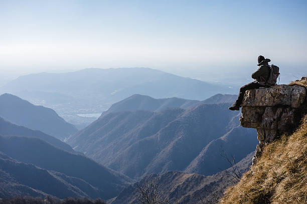 Hiker climber resting on top mountain