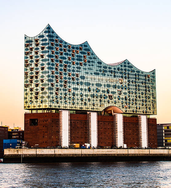 Hamburg, Germany - February 02, 2016: River Elbe and Elbhilharmonie at sunset. The Elbphilharmonie is a concert hall finished in the HafenCity quarter. The new construction sits on top of an old warehouse building.