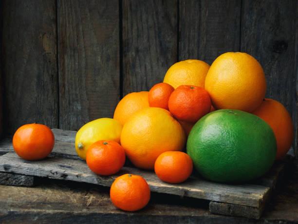 istock composition of citrus: tangerines, oranges, sweetie, lemon. Side view 638232470
