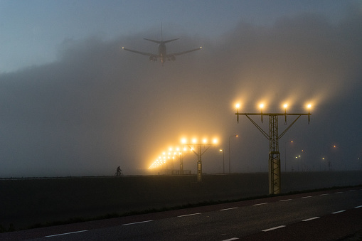 Arrival of a plane at Schiphol airport in the Netherlands on a foggy morning