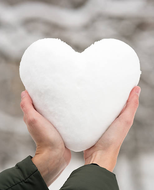 istock Female Hands holding a Snow Heart, Winter Love 638233452