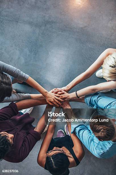 Stack Of Hands Symbolizing Trust And Cooperation Stock Photo - Download Image Now - Teamwork, Community, Multiracial Group
