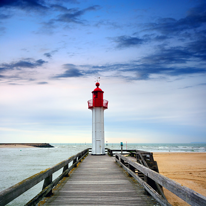 Lighthouse in Trouville-sur-Mer harbor, Normandy, France. Composite photo