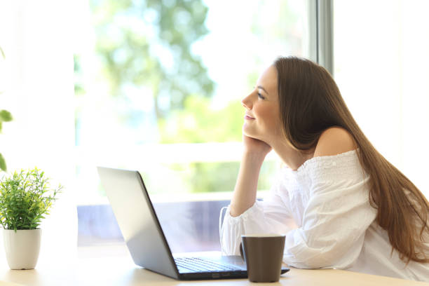 istock Girl dreaming looking through a window 638238276