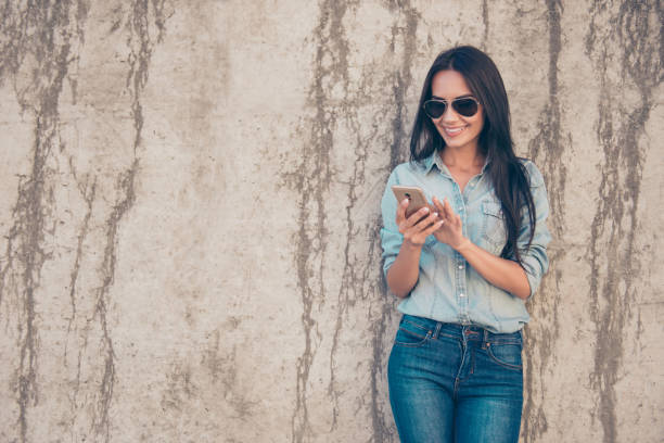 istock Happy young woman using her smartphone for communication 638238286