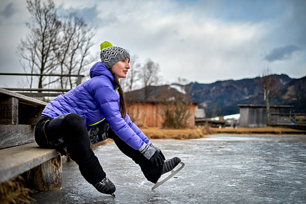 istock Woman fixing ice skate shoe 638240598