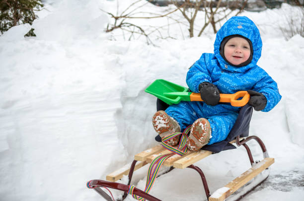 istock Kid sliding with sledding in the snow 638241402